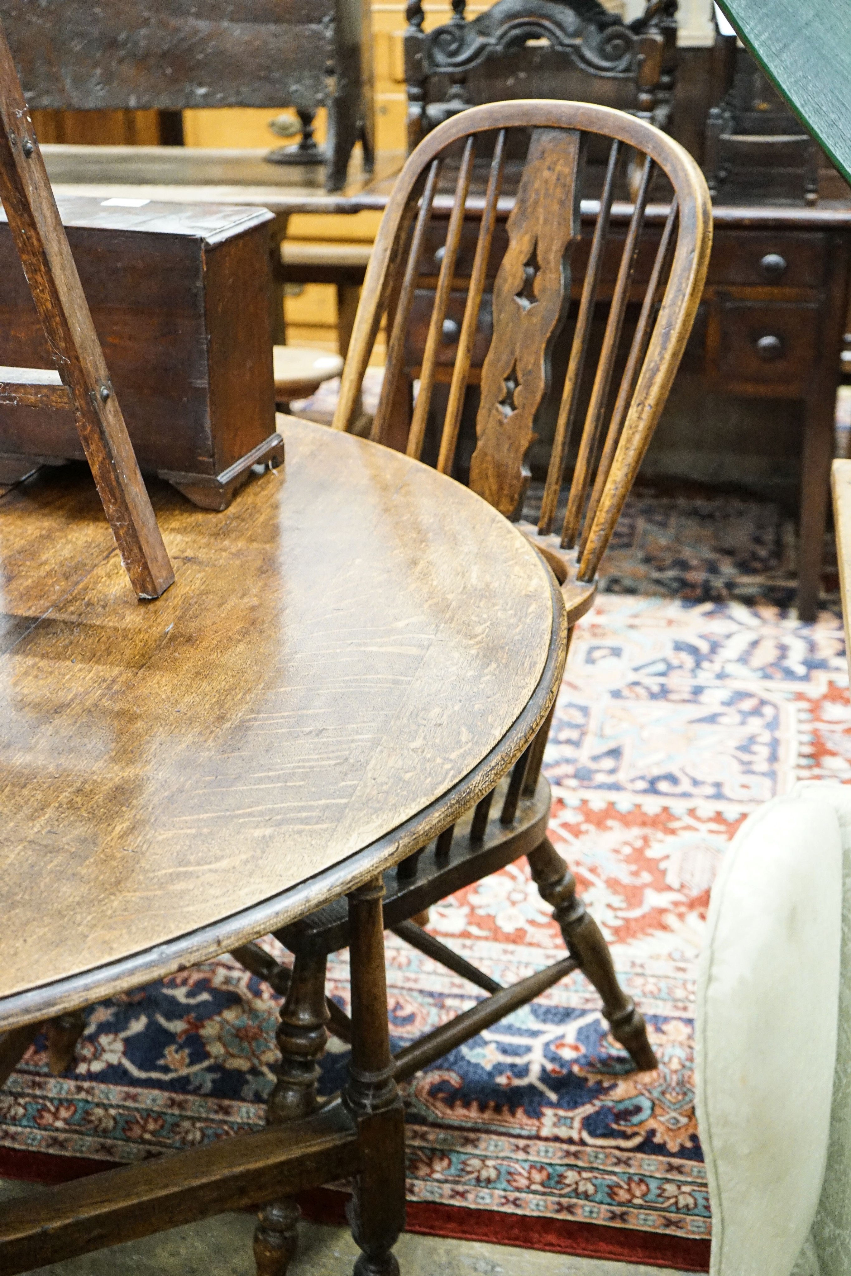 A harlequin set of four Victorian Windsor chairs, comprising near pair of yew, beech and elm, with crinoline stretchers and two others in oak, elm and ash with H stretchers